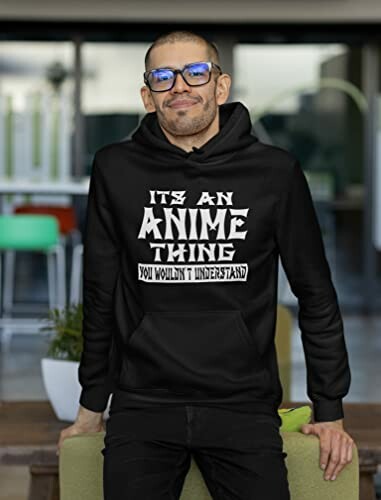 Man wearing a black hoodie with anime-themed text.